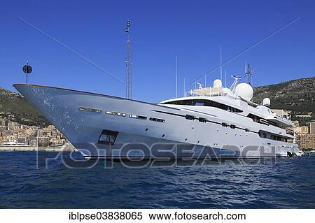 Stock Photography - CRN motor yacht Il Vagabondo at anchor in front of the Principality of Monaco. Fotosearch