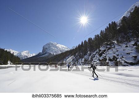 Stock Photography - "Cross-country skiers in front of Mt Rosskopfspitze, Risstal, Rissbachtal, Karwendel Mountains, Tyrol, Austria, Europe". Fotosearch