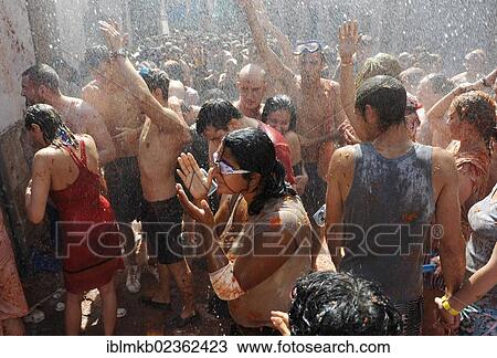 "Crowd being spattered with water, Tomatina tomato festival, Bunol, Spain, Europe" View Large Photo Image Stock Image - "Crowd being spattered with water, Tomatina tomato festival, Bunol, Spain, Europe". Fotosearch