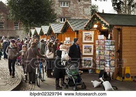 Picture - Crowds enjoy shopping at the christmas market bu the cathedral in Winchester. Fotosearch