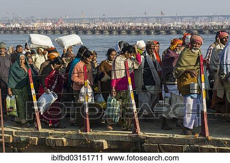 Stock Image - "Crowds of people arriving at Kumbha Mela grounds, walking on pontoon bridges, Allahabad, Uttar Pradesh, India, Asia". Fotosearch