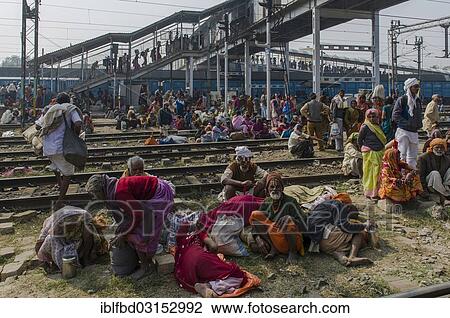 Stock Image - "Crowds of people waiting for delayed trains all over the railway station, Allahabad, Uttar Pradesh, India, Asia". Fotosearch