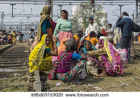 Stock Image - "Crowds of people waiting for delayed trains all over the railway station, Allahabad, Uttar Pradesh, India, Asia". Fotosearch