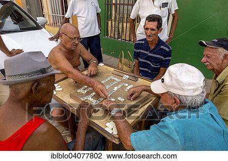 "Cuban men playing dominoes at a table outside, old town, Trinidad, Sancti Spiritus Province, Cuba, North America" View Large Photo Image Stock Image - "Cuban men playing dominoes at a table outside, old town, Trinidad, Sancti Spiritus Province, Cuba, North America". Fotosearch