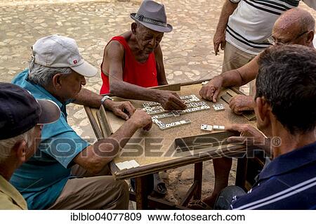 "Cuban men playing dominoes at a table outside, old town, Trinidad, Sancti Spiritus Province, Cuba, North America" View Large Photo Image Stock Photo - "Cuban men playing dominoes at a table outside, old town, Trinidad, Sancti Spiritus Province, Cuba, North America". Fotosearch
