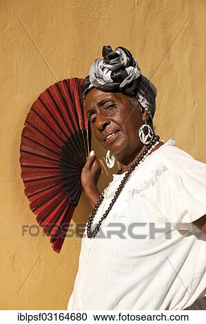 "Cuban woman holding a red fan, Havana, Cuba, North America" View Large Photo Image Stock Image - "Cuban woman holding a red fan, Havana, Cuba, North America". Fotosearch