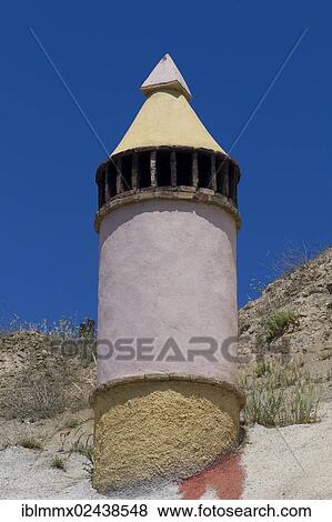 Stock Photo - "Cuevas La Granja, chimney, cave dwellings, modern designer hotel built deep into a rock to provide a pleasant climate in the rooms throughout the year, Benalua, Andalusia, Spain, Europe". Fotosearch