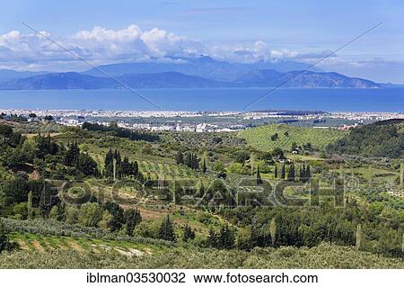 Stock Image - "Cultural landscape on the Aegean coast, view over Guezelcamli towards the Greek island of Samos, Guzelcamli, near Kusadasi, Aydin province, Aegean region, Turkey, Asia". Fotosearch