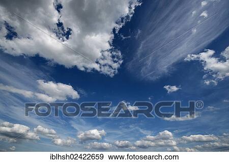 Cumulus and cirrostratus clous against a blue sky View Large Photo Image Stock Photo - Cumulus and cirrostratus clous against a blue sky. Fotosearch
