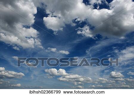 Cumulus and cirrus clouds in the sky View Large Photo Image Stock Photo - Cumulus and cirrus clouds in the sky. Fotosearch