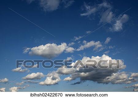Stock Image - Cumulus clouds against a blue sky. Fotosearch