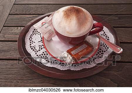 Cup of cappuccino on a wooden table View Large Photo Image Stock Photograph - Cup of cappuccino on a wooden table. Fotosearch
