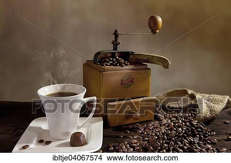 "Cup of hot coffee, coffee grinder and coffee beans" View Large Photo Image Picture - "Cup of hot coffee, coffee grinder and coffee beans". Fotosearch