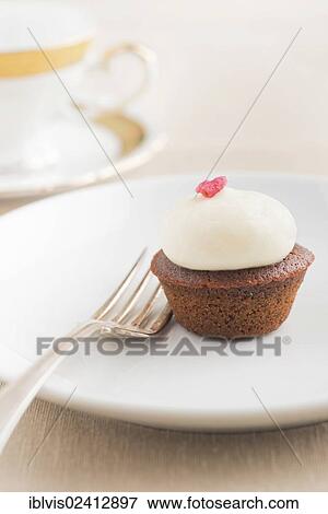 Cupcake on a plate with fork View Large Photo Image Stock Photo - Cupcake on a plate with fork. Fotosearch