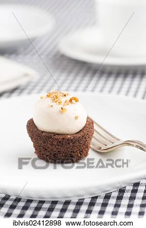 Cupcake on a plate with fork View Large Photo Image Stock Photo - Cupcake on a plate with fork. Fotosearch