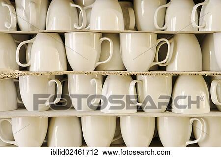 Cups piled between cardboard View Large Photo Image Stock Image - Cups piled between cardboard. Fotosearch