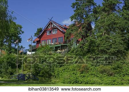 "Curonian flags in front of a traditional wooden house, Nida, KlaipÄ—da County, Lithuania, Europe" View Large Photo Image Stock Photo - "Curonian flags in front of a traditional wooden house, Nida, KlaipÄ—da County, Lithuania, Europe". Fotosearch