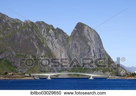 Stock Image - "Curved bridge crossing a fjord, Reine, Moskenesoy, Lofoten, Nordland, Norway, Europe". Fotosearch