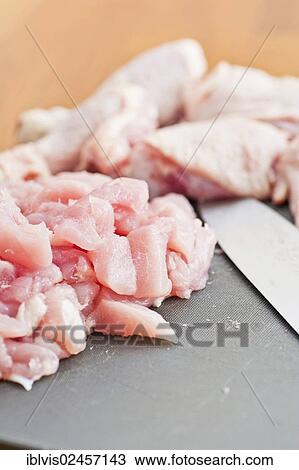 Cut up pieces of uncooked chicken on a plastic cutting board View Large Photo Image Stock Image - Cut up pieces of uncooked chicken on a plastic cutting board. Fotosearch