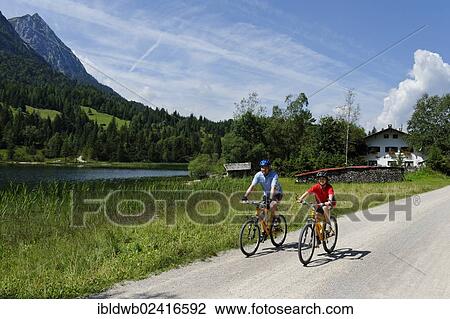 Cycling tour with mountain bikes, father and son at Lake Ferchensee, Mittenwald, Karwendel Mountains, Werdenfelser Land, Upper Bavaria, Bavaria, Germany, Europe View Large Photo Image Stock Image - Cycling tour with mountain bikes, father and son at Lake Ferchensee, Mittenwald, Karwendel Mountains, Werdenfelser Land, Upper Bavaria, Bavaria, Germany, Europe. Fotosearch