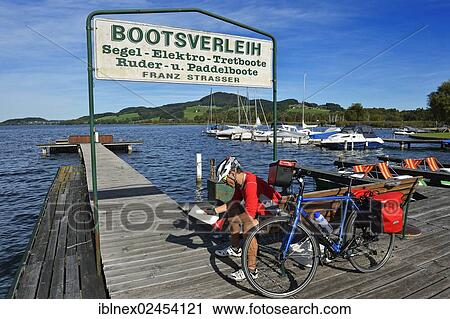Stock Image - "Cyclist at Obertrumer See lake, Salzburg Lake District, Salzburg State, Austria, Europe". Fotosearch