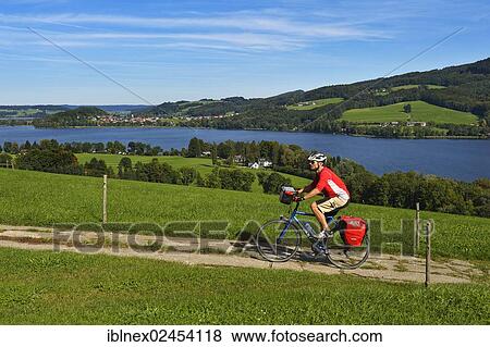 "Cyclist at Obertrumer See Lake, Salzburg Lake District, Salzburg State, Austria, Europe" View Large Photo Image Stock Photo - "Cyclist at Obertrumer See Lake, Salzburg Lake District, Salzburg State, Austria, Europe". Fotosearch