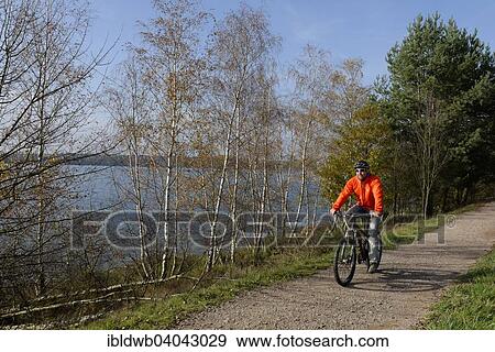 "Cyclist, bicycle tour at Murner See lake, Upper Palatinate Lakeland, near Wackersdorf, Upper Palatinate, Bavaria, Germany, Europe" View Large Photo Image Stock Photo - "Cyclist, bicycle tour at Murner See lake, Upper Palatinate Lakeland, near Wackersdorf, Upper Palatinate, Bavaria, Germany, Europe". Fotosearch