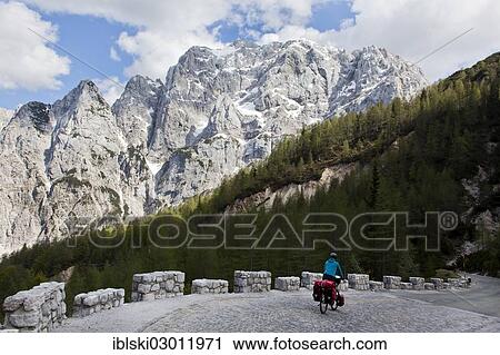"Cyclist in the mountain landscape near the Vrsic Pass with the 2547m high Prisojnik Mountain, Triglav National Park, Julian Alps, near Bovec, Slovenia, Europe" View Large Photo Image Stock Image - "Cyclist in the mountain landscape near the Vrsic Pass with the 2547m high Prisojnik Mountain, Triglav National Park, Julian Alps, near Bovec, Slovenia, Europe". Fotosearch