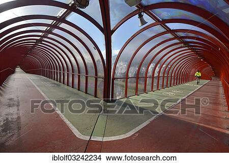 "Cyclist is riding on a covered footbridge and bicycle bridge, Glasgow, Scotland, United Kingdom, Europe" View Large Photo Image Picture - "Cyclist is riding on a covered footbridge and bicycle bridge, Glasgow, Scotland, United Kingdom, Europe". Fotosearch
