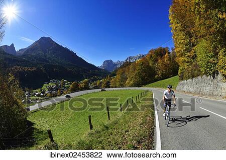"Cyclist riding along the Hochalpenstrasse, a high alpine road between Bischofswiesen and Berchtesgaden, Upper Bavaria, Bavaria, Germany, Europe" View Large Photo Image Stock Image - "Cyclist riding along the Hochalpenstrasse, a high alpine road between Bischofswiesen and Berchtesgaden, Upper Bavaria, Bavaria, Germany, Europe". Fotosearch