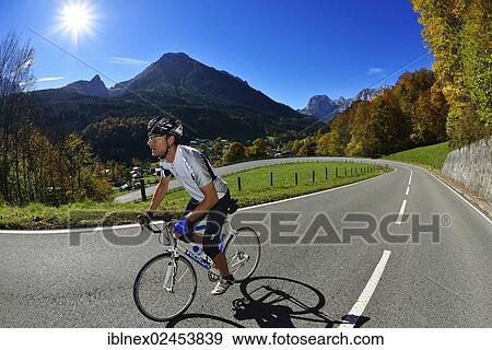 Stock Photo - "Cyclist riding along the Hochalpenstrasse, a high alpine road between Bischofswiesen and Berchtesgaden, Upper Bavaria, Bavaria, Germany, Europe". Fotosearch