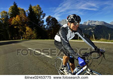 "Cyclist riding along the Obersalzbergstrasse, Watzmann Mountain, Berchtesgaden, Upper Bavaria, Bavaria, Germany, Europe" View Large Photo Image Stock Photography - "Cyclist riding along the Obersalzbergstrasse, Watzmann Mountain, Berchtesgaden, Upper Bavaria, Bavaria, Germany, Europe". Fotosearch