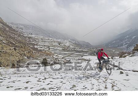 "Cyclist riding his bike in the snow up towards Thorong La Pass (5416 m), Manang, Annapurna Region, Nepal, Asia" View Large Photo Image Stock Photograph - "Cyclist riding his bike in the snow up towards Thorong La Pass (5416 m), Manang, Annapurna Region, Nepal, Asia". Fotosearch