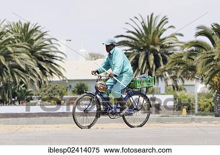 Stock Photography - Cyclist, Walvis Bay, Walvis Bay City, Namibia, Africa. Fotosearch