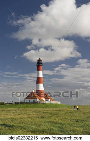 Stock Photography - "Cyclists at the Westerheversand lighthouse, Westerhever, Eiderstedt, North Frisia, Schleswig-Holstein, Germany, Europe". Fotosearch
