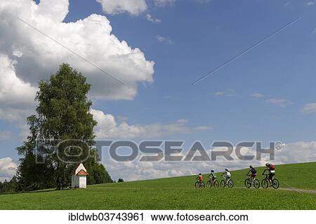 "Cyclists on a bicycle tour near a small chapel, Seeg, Swabia, Bavaria, Germany, Europe" View Large Photo Image Stock Image - "Cyclists on a bicycle tour near a small chapel, Seeg, Swabia, Bavaria, Germany, Europe". Fotosearch