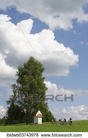 "Cyclists on a bicycle tour near a small chapel, Seeg, Swabia, Bavaria, Germany, Europe" View Large Photo Image Stock Photo - "Cyclists on a bicycle tour near a small chapel, Seeg, Swabia, Bavaria, Germany, Europe". Fotosearch