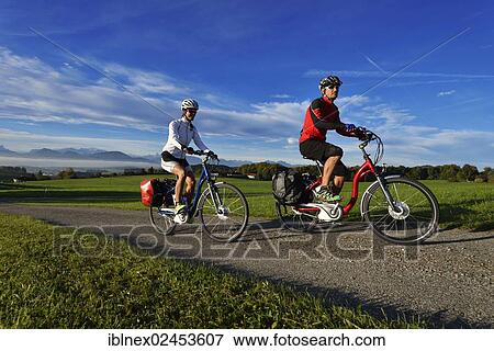 "Cyclists riding electric bicycles on Tannberg Mountain, Koestendorf, Lake Waller, Salzburg Lake District, Salzburg, Austria, Europe" View Large Photo Image Stock Photo - "Cyclists riding electric bicycles on Tannberg Mountain, Koestendorf, Lake Waller, Salzburg Lake District, Salzburg, Austria, Europe". Fotosearch