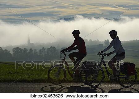 "Cyclists riding electric bicycles on Tannberg Mountain, Koestendorf, Lake Waller, Salzburg Lake District, Salzburg, Austria, Europe Models Released, Europe" View Large Photo Image Stock Photograph - "Cyclists riding electric bicycles on Tannberg Mountain, Koestendorf, Lake Waller, Salzburg Lake District, Salzburg, Austria, Europe Models Released, Europe". Fotosearch