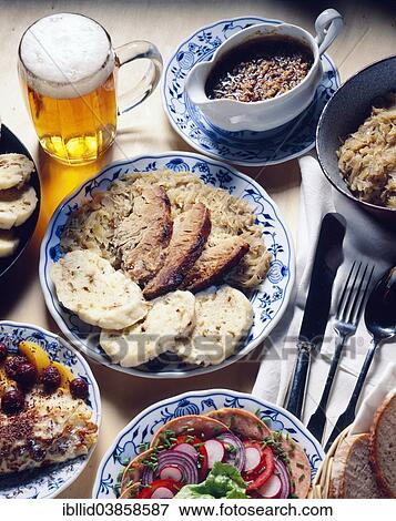 "Czech national cuisine, salad made with sausages, roast pork with sauerkraut and dumplings, pancakes, beer" View Large Photo Image Stock Photo - "Czech national cuisine, salad made with sausages, roast pork with sauerkraut and dumplings, pancakes, beer". Fotosearch