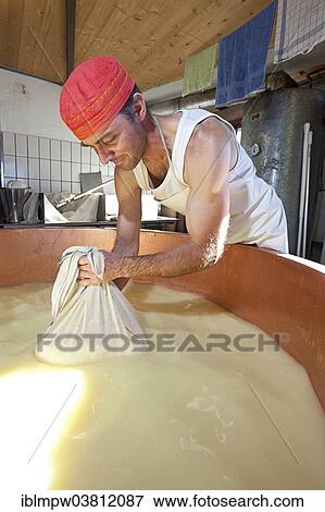 "Dairyman drawing cottage cheese with a cloth from the copper kettle for a first test, draining off the whey, Alp Gun, Graubunden, Switzerland, Europe" View Large Photo Image Stock Photo - "Dairyman drawing cottage cheese with a cloth from the copper kettle for a first test, draining off the whey, Alp Gun, Graubunden, Switzerland, Europe". Fotosearch