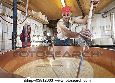 "Dairyman mixing the whey and the curd with a cheese harp in a copper kettle, Alp Gun, Graubunden, Switzerland, Europe" View Large Photo Image Stock Image - "Dairyman mixing the whey and the curd with a cheese harp in a copper kettle, Alp Gun, Graubunden, Switzerland, Europe". Fotosearch