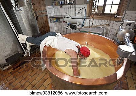 "Dairyman spreading the cloth in a copper kettle to separate the whey from the curd and to skim off the cottage cheese, Alp Gun, Graubunden, Switzerland, Europe" View Large Photo Image Stock Photograph - "Dairyman spreading the cloth in a copper kettle to separate the whey from the curd and to skim off the cottage cheese, Alp Gun, Graubunden, Switzerland, Europe". Fotosearch