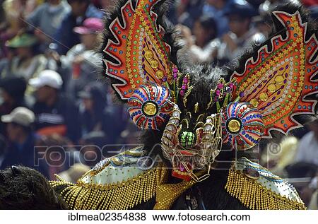 Stock Photo - "Dancer with a mask at the world's biggest Indian carnival festival, living UNESCO World Heritage Site, Diablada, Oruro, Bolivia, South America". Fotosearch