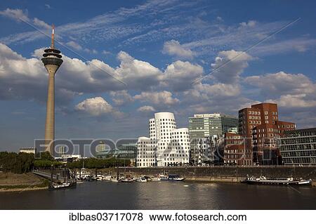 "Dancing Office Towers designed by Frank O. Gehry in Medienhafen or Media Harbour, Duesseldorf Marina, left the Rhine Tower, Medienhafen, Dusseldorf, Rhineland, North Rhine-Westphalia, Germany, Europe" View Large Photo Image Stock Photo - "Dancing Office Towers designed by Frank O. Gehry in Medienhafen or Media Harbour, Duesseldorf Marina, left the Rhine Tower, Medienhafen, Dusseldorf, Rhineland, North Rhine-Westphalia, Germany, Europe". Fotosearch