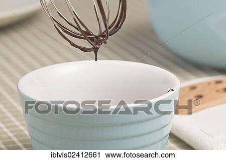 Dark chocolate dripping from wire whisk View Large Photo Image Stock Image - Dark chocolate dripping from wire whisk. Fotosearch