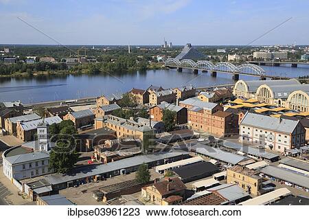 "Daugava River with the Railway Bridge or Dzelzceļa Tilts and the New National Library, market halls and the Spikeri warehouse complex, view from high-rise tower of the Academy of Sciences, Riga, Latvia, Europe" View Large Photo Image Stock Image - "Daugava River with the Railway Bridge or Dzelzceļa Tilts and the New National Library, market halls and the Spikeri warehouse complex, view from high-rise tower of the Academy of Sciences, Riga, Latvia, Europe". Fotosearch
