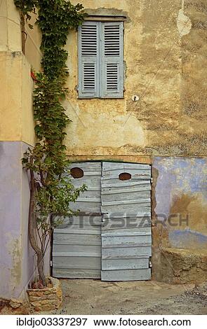 "Decaying facade with a door and closed window shutters, Montemaggiore, Corsica, France, Europe" View Large Photo Image Stock Photo - "Decaying facade with a door and closed window shutters, Montemaggiore, Corsica, France, Europe". Fotosearch
