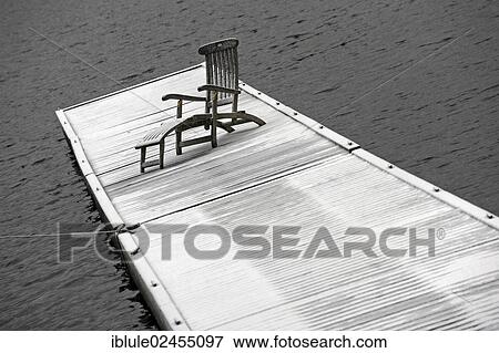 Stock Photo - "Deck chair on snow-covered jetty at Spitzingsee Lake, Bayrischzell, Bavaria, Germany, Europe". Fotosearch
