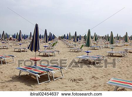 Stock Photo - "Deck chairs and parasols on the beach of Lignano, Friuli Venezia Giulia, Italy, Europe, PublicGround, Europe". Fotosearch